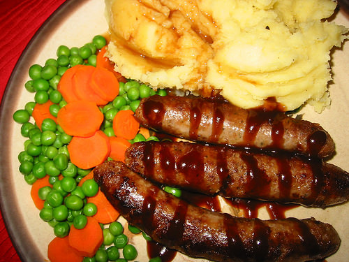 Sausages, mash, carrots and peas