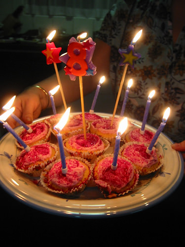 Birthday cupcakes, candles lit