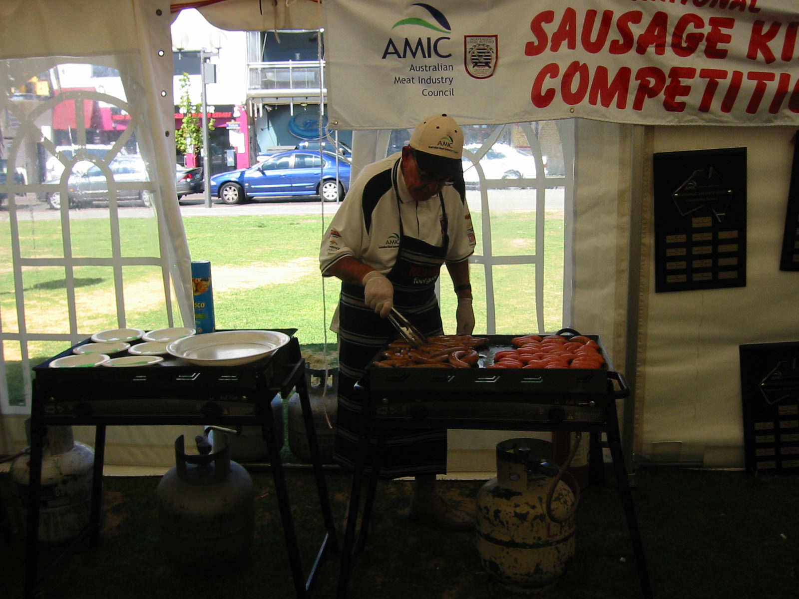 Butcher BBQ'ing sausages