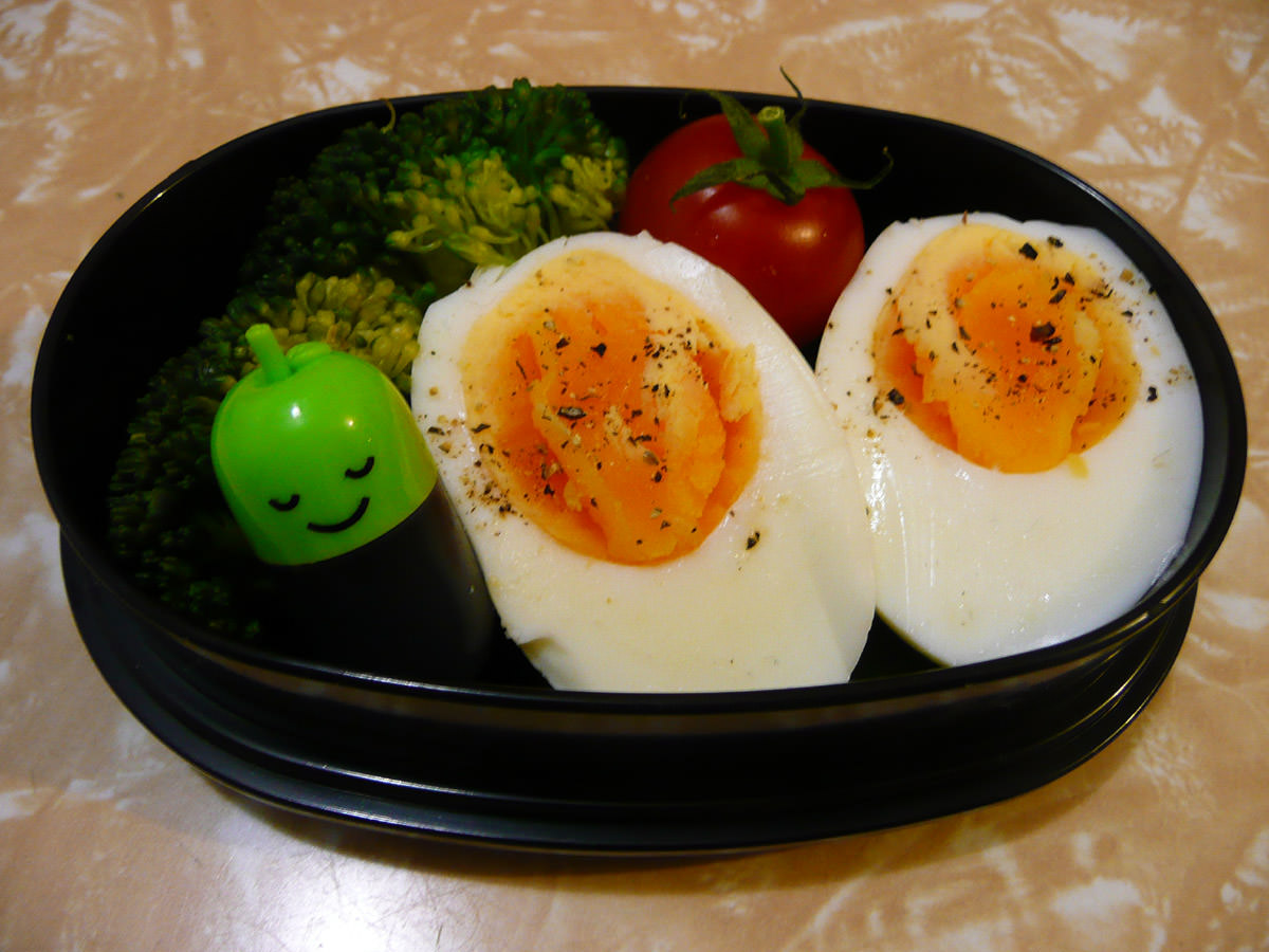 Hard-boiled eggs with soy sauce, broccoli and cherry tomato