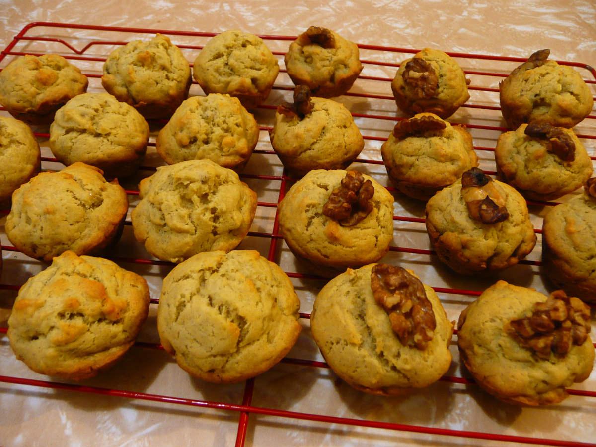 Mini banana muffins, some topped with walnut