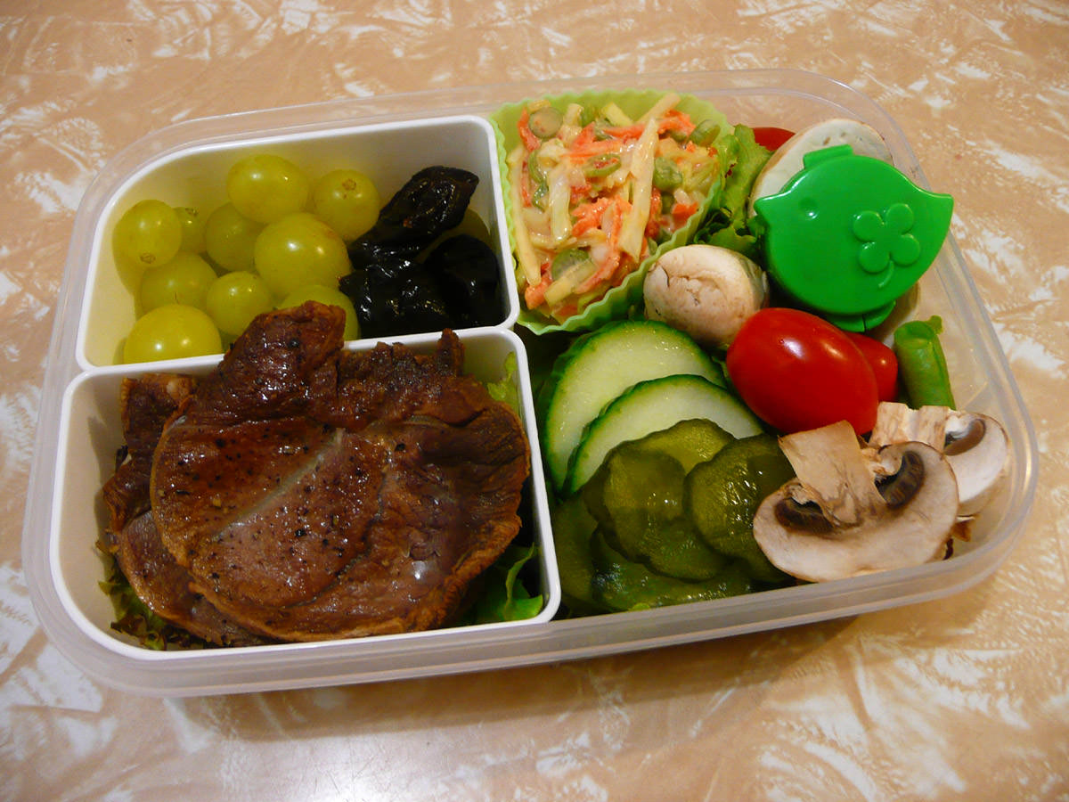 Bento - lamb steaks, salad, pickles, coleslaw, fruit