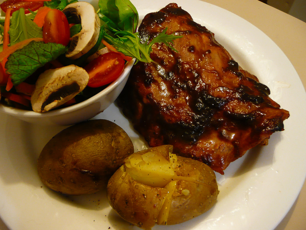 Barbecue pork ribs, salad and baked potatoes