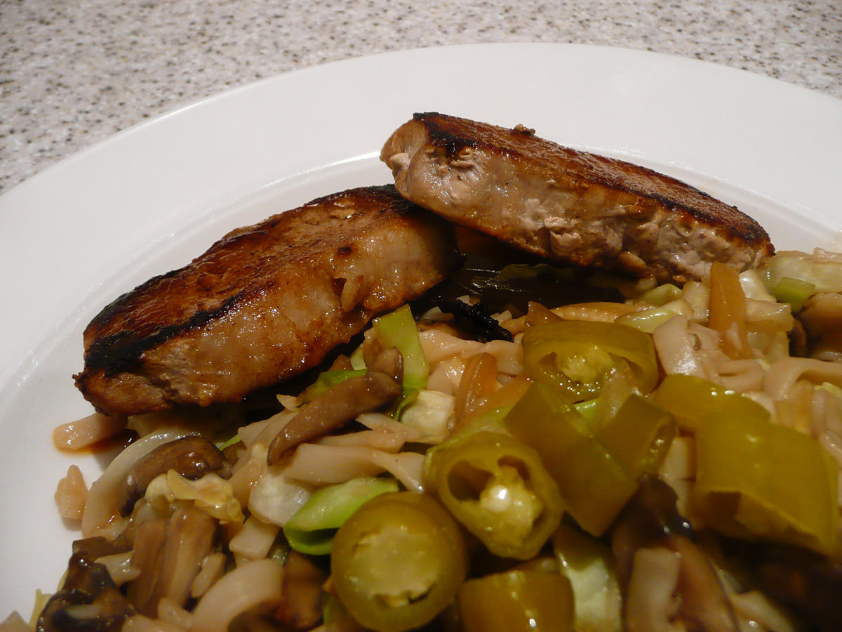 Pork steaks with noodles and pickled green chillies