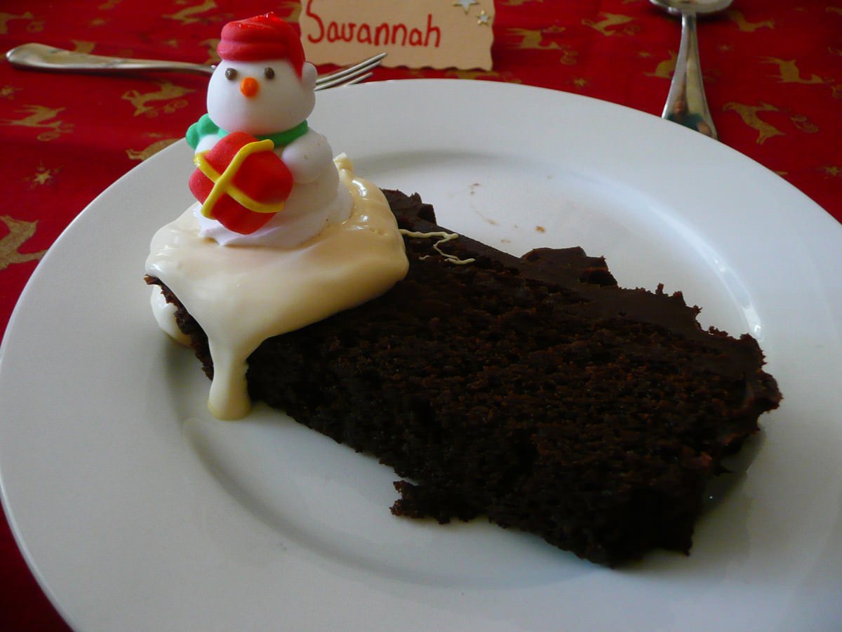 Christmas chocolate cake with brandy cream and the snowman from the top of the cake