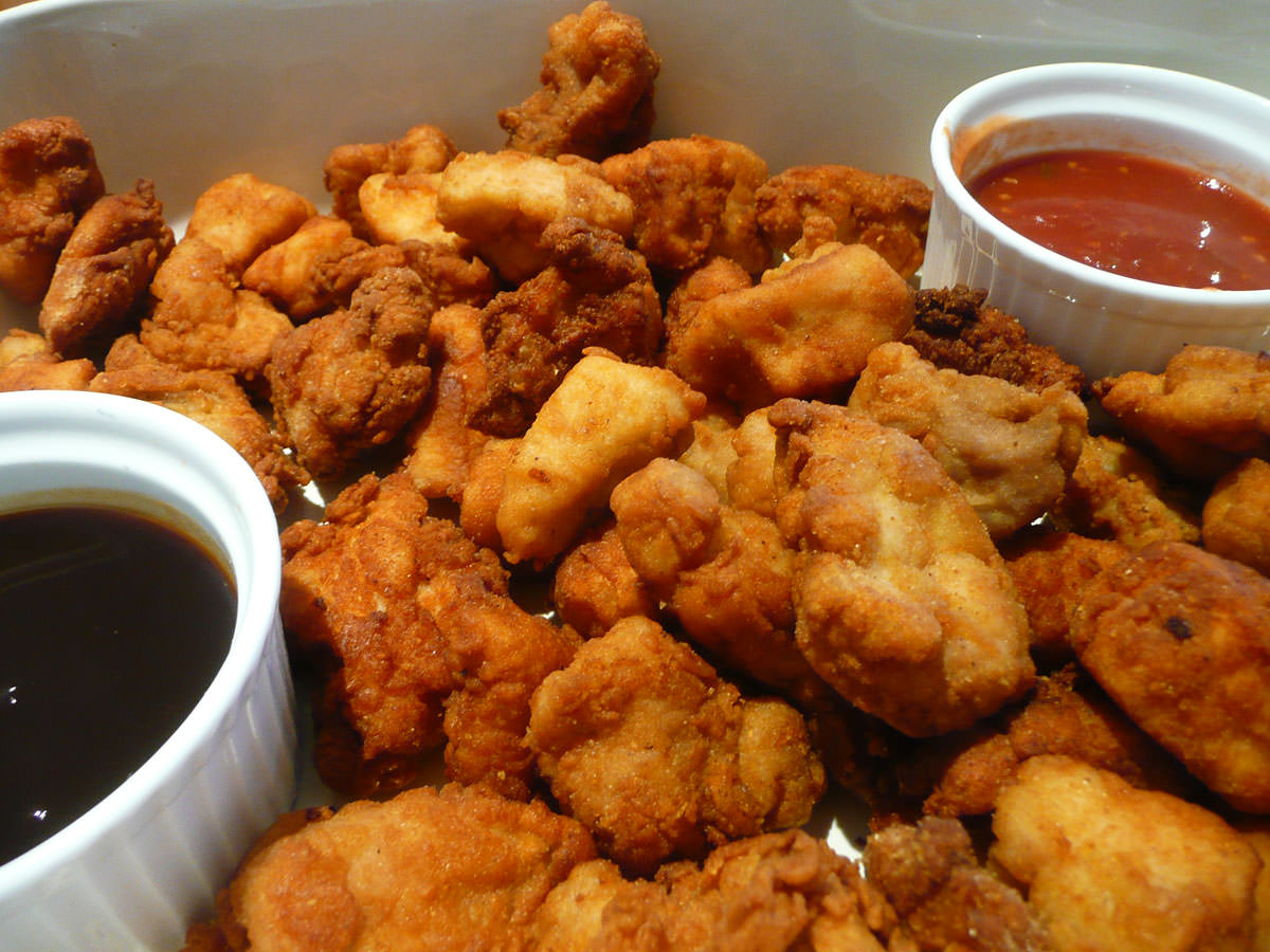 Chicken nuggets with barbecue and chilli sauces - close-up