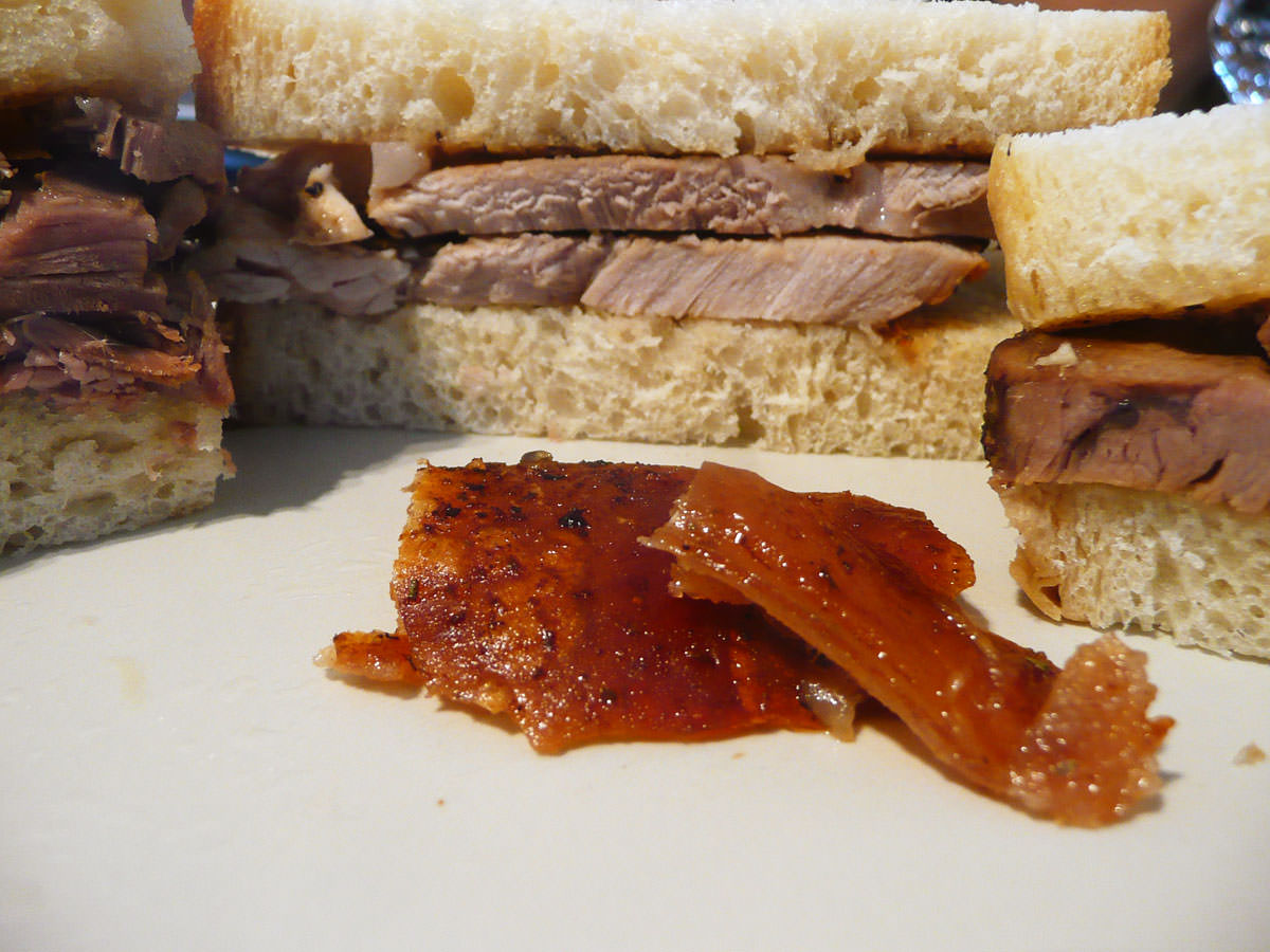Roast pork crackling surrounded by a wall of roast meat sandwiches
