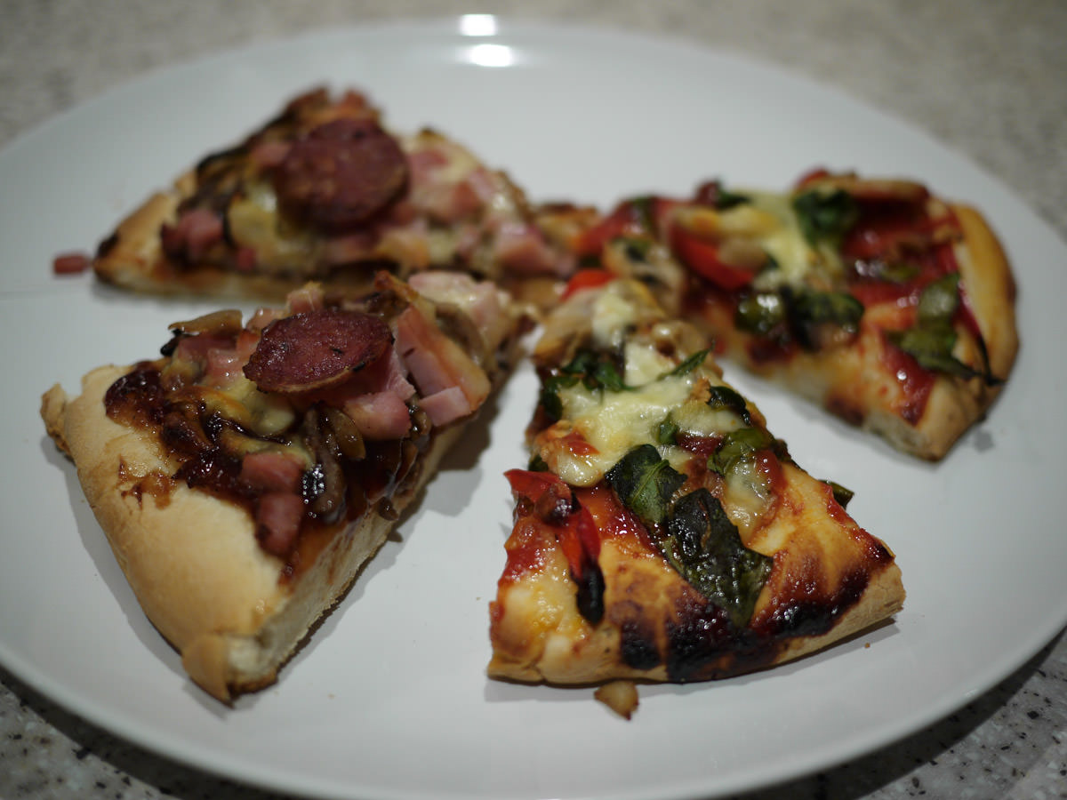 Vegetarian pizza and meatlovers pizza slices