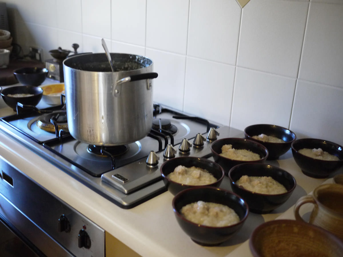 Pork rice porridge (chok) - pot on stove and serving bowls