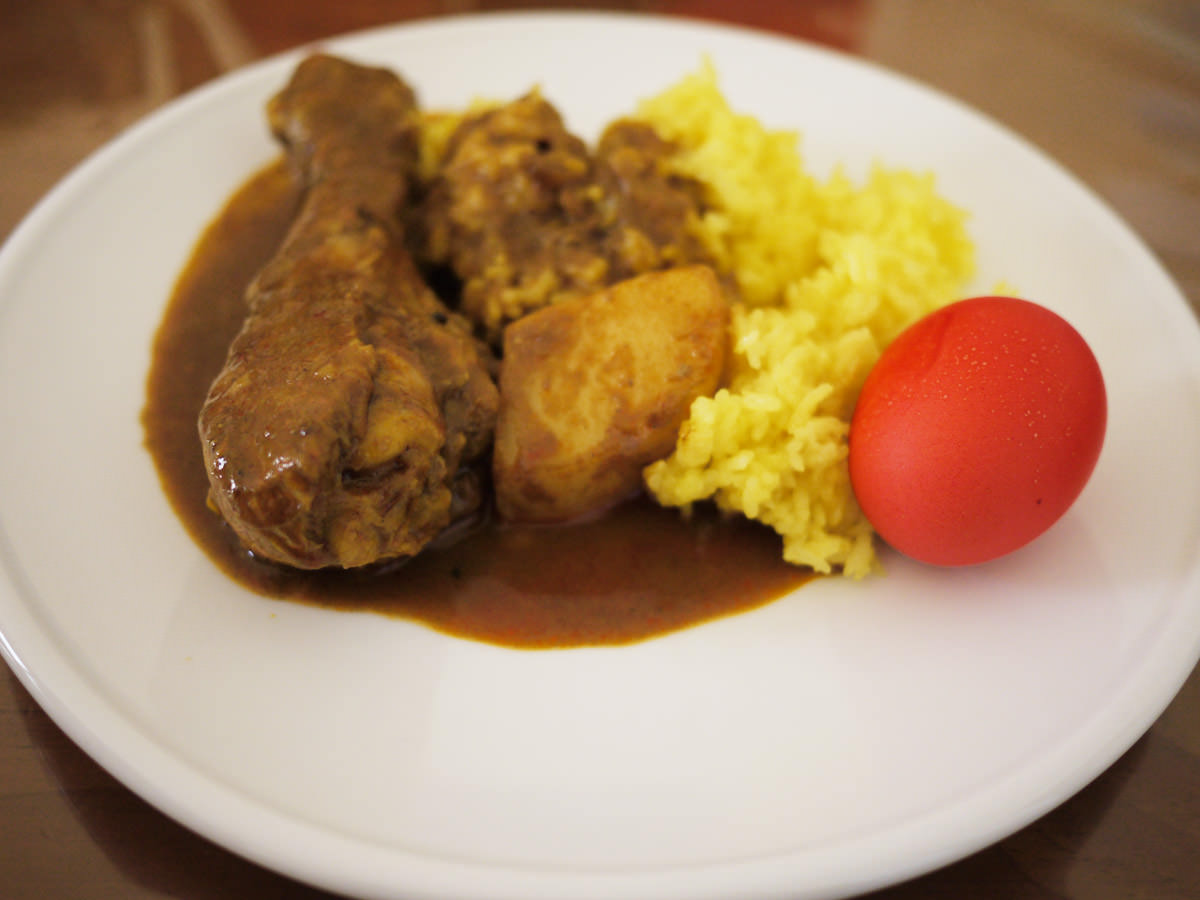 My plate: Chicken curry, yellow rice and red egg