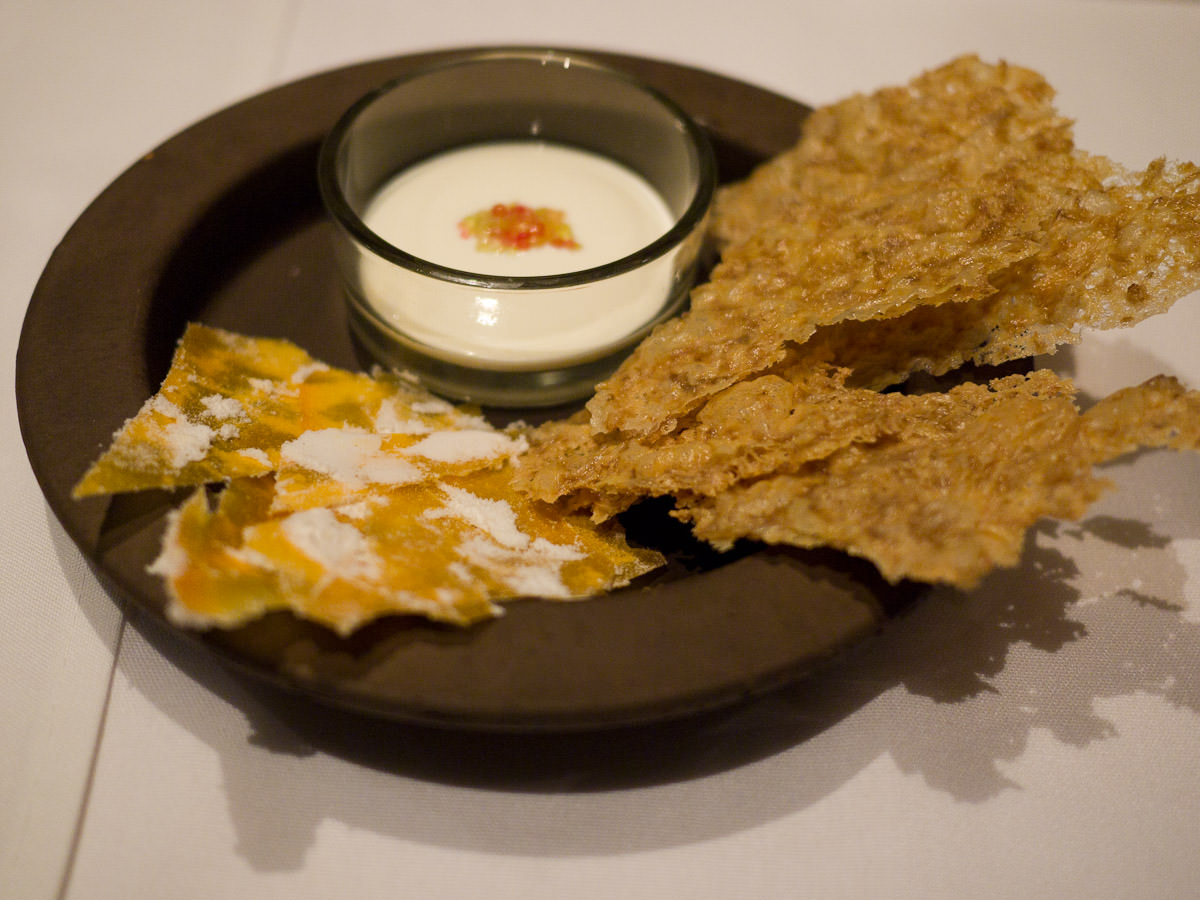 Oat crisps and pumpkin crisps with sour cream and finger limes