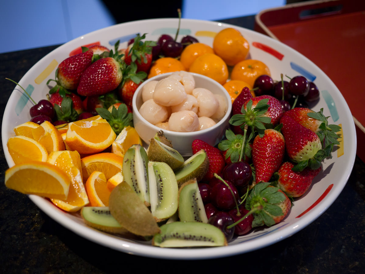 Fruit platter with mandarins, oranges, strawberries, cherries, kiwifruit and tinned lychees