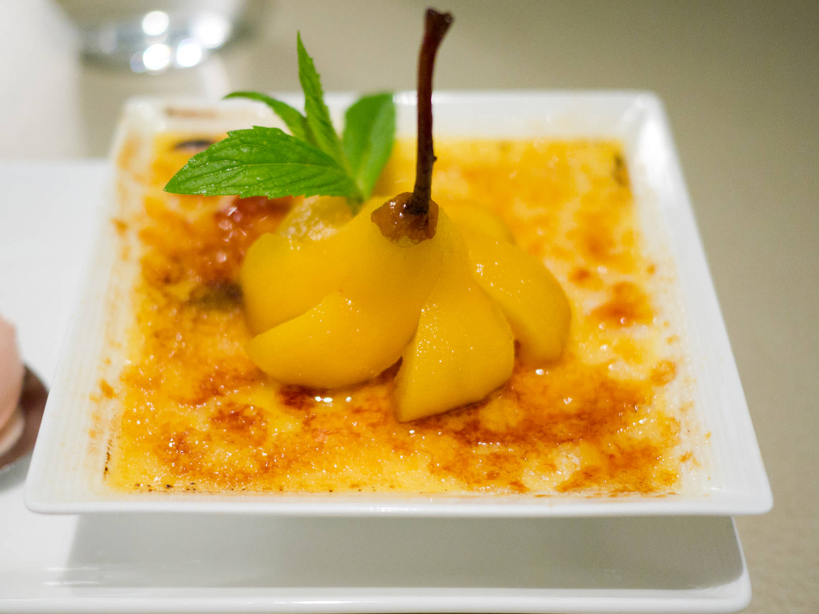 Creme brulee, poached pear in saffron and pinot grigio