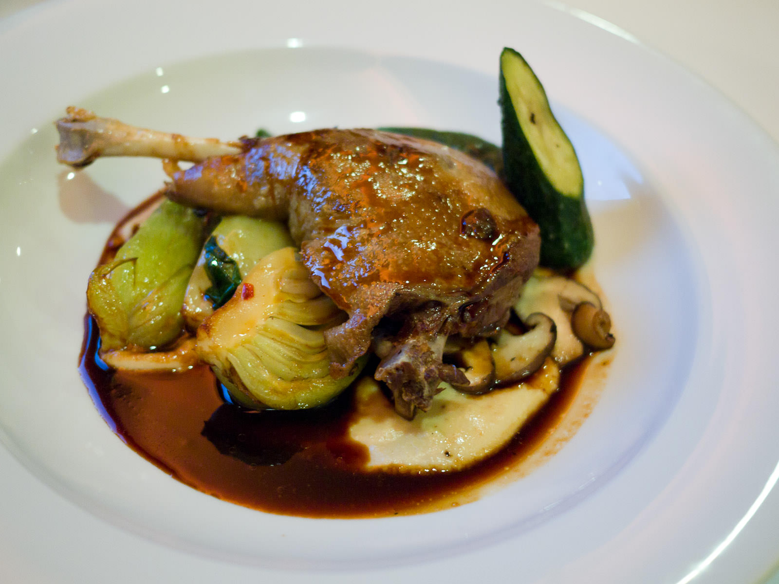 Confit of duck leg, macadamia and celeriac puree, baby boy choy, courgettes, shitake mushrooms, spicy plum jus