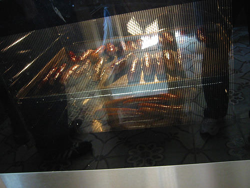 Sausages, glistening in the oven