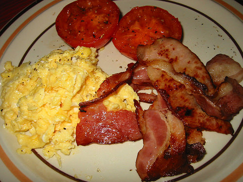 Bacon, scrambled eggs and fried tomato
