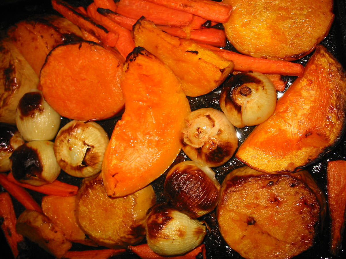 Roast pumpkin, onions and carrots in oven tray