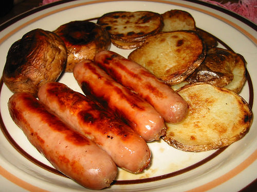 Pork chipolatas, panfried sliced potato and mushrooms