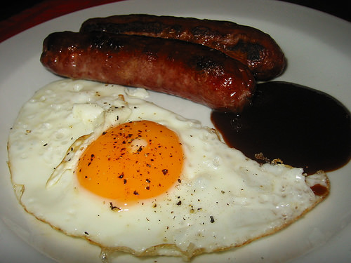 Sausages and eggs, peppered and BBQ sauced