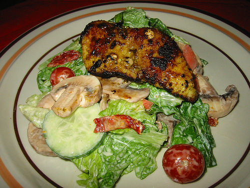 Lemon pepper fish served on salad with ranch dressing