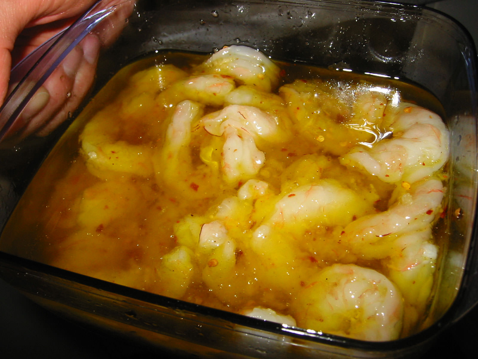 Uncooked prawns in oil and garlic