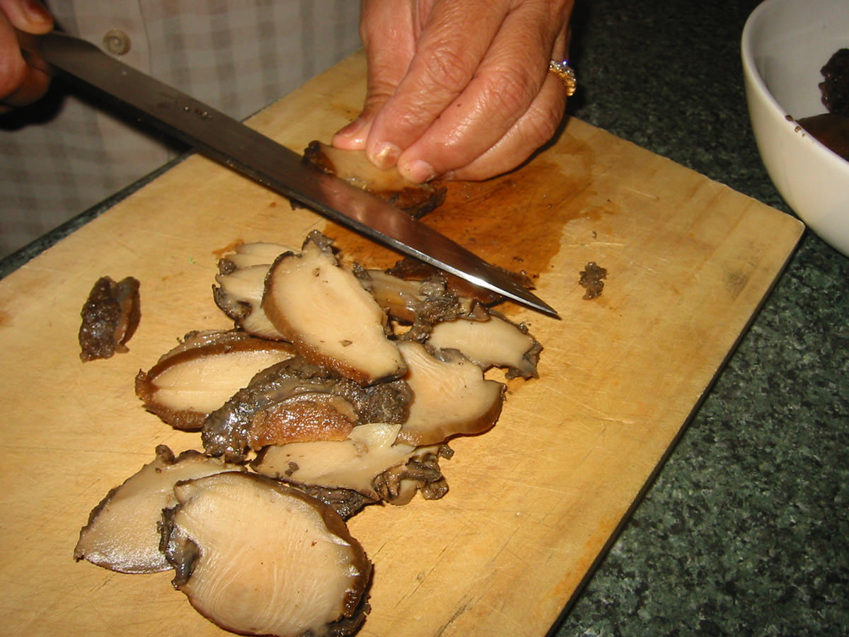Slicing the cooked abalone