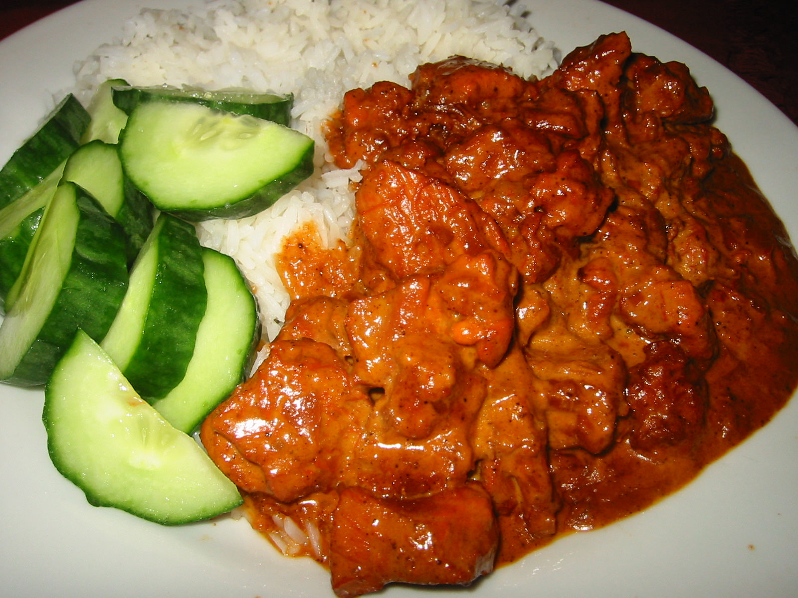 Butter chicken, cucumber, and rice