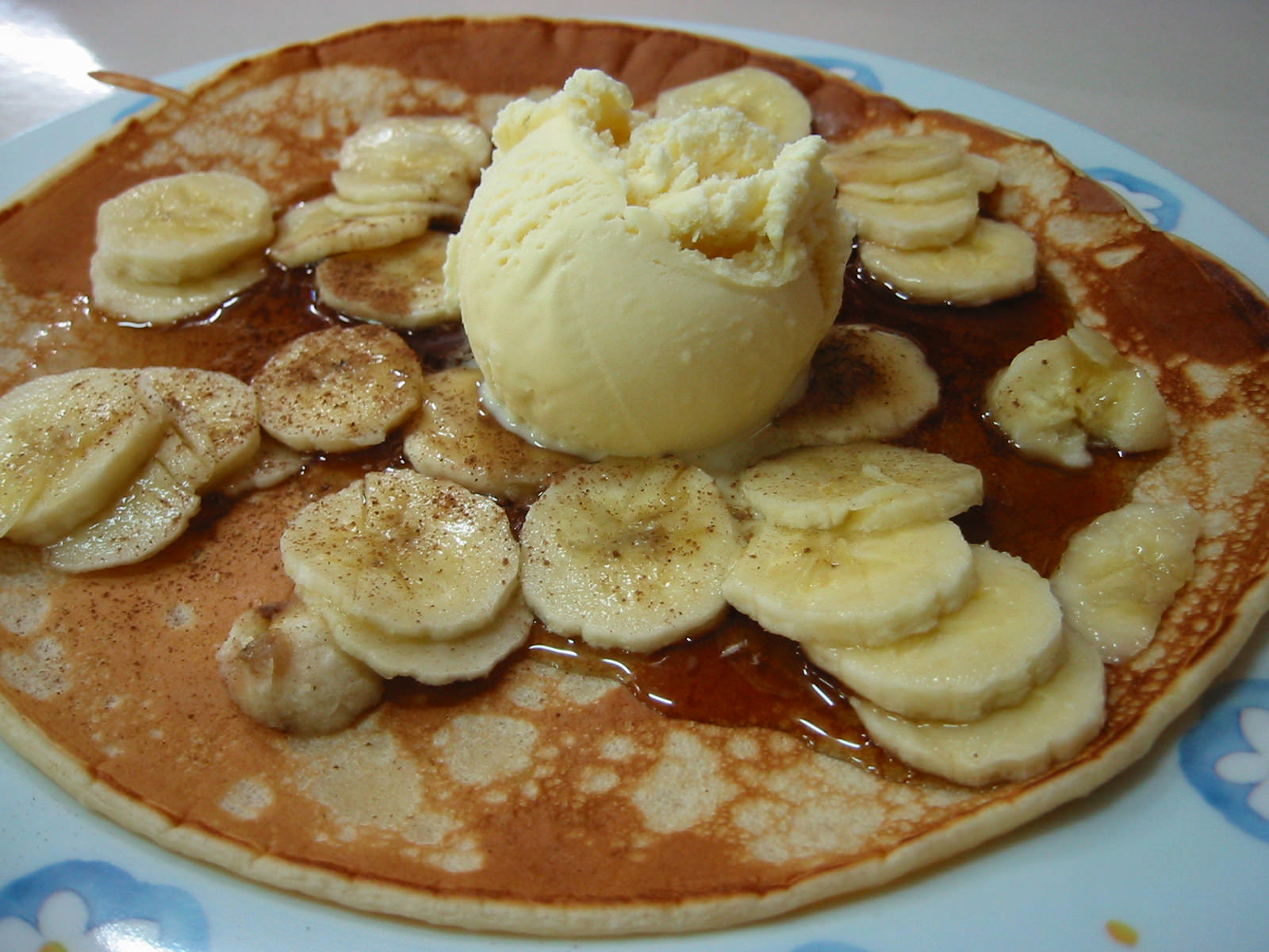 Pancake with banana, maple syrup and ice cream