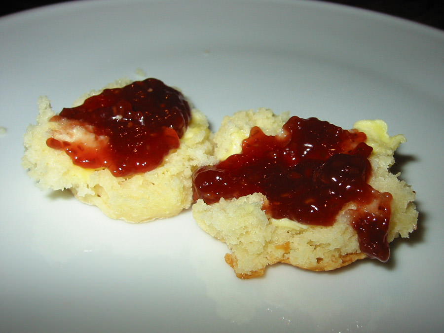 Scone with butter and strawberry jam