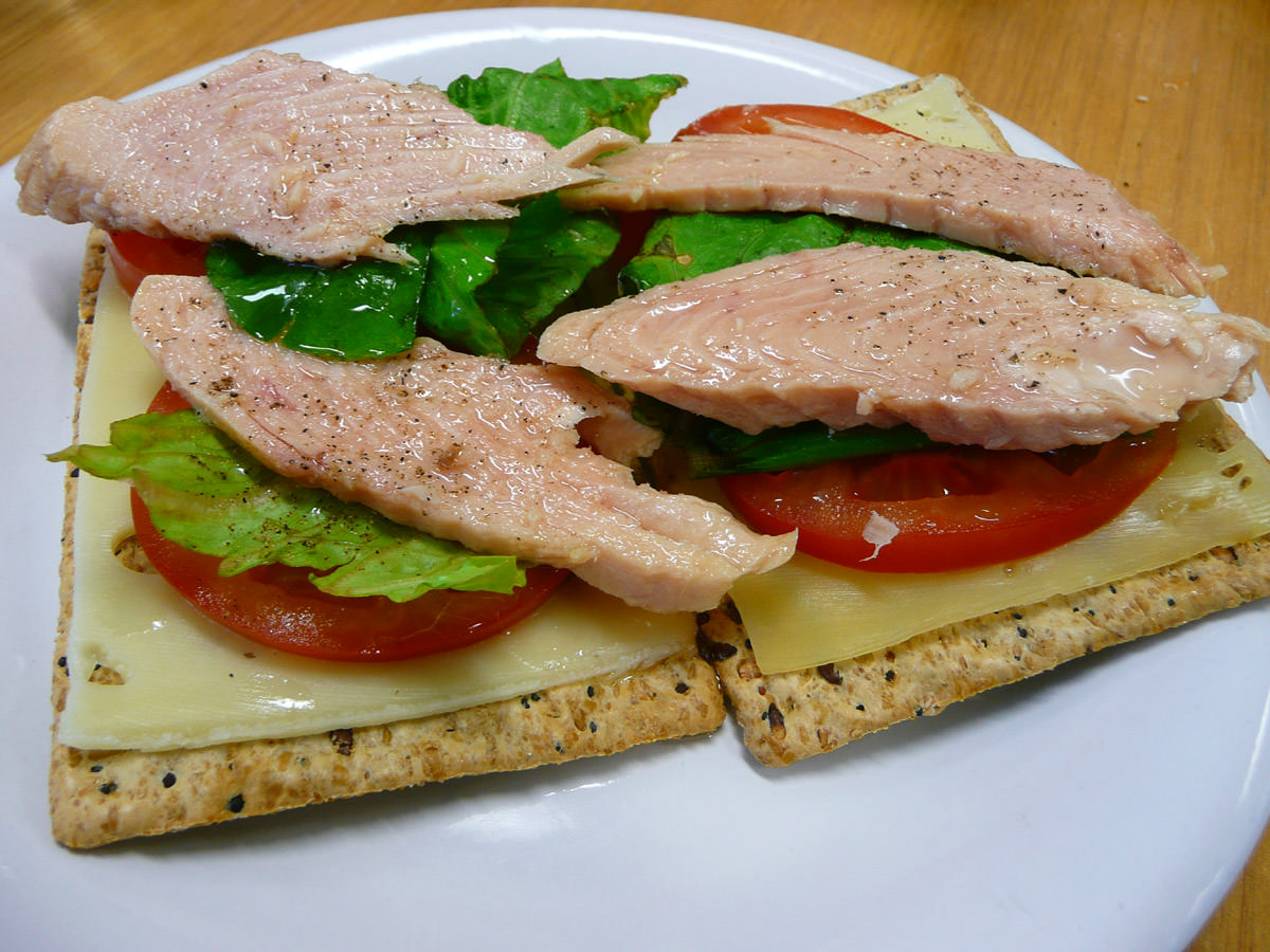 Tuna, lettuce, tomato and swiss cheese on crackers
