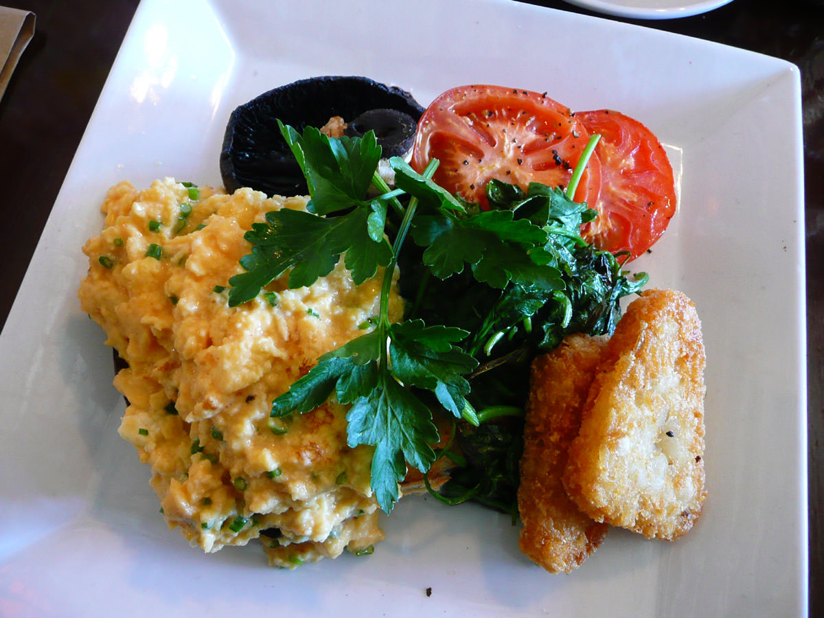 Vegetarian breakfast - scrambled eggs with fetta and chives, mushroom, spinach, tomato, hash brown and ciabatta toast
