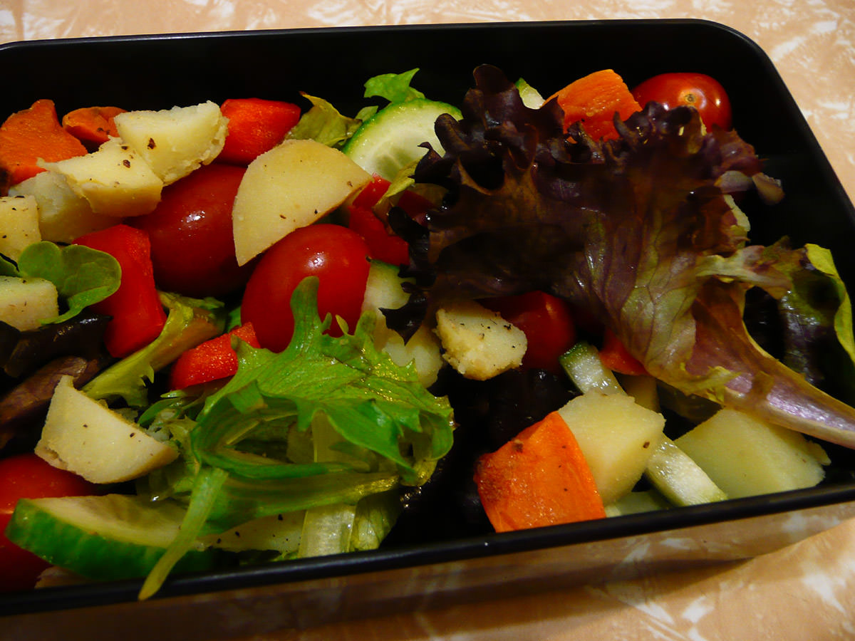 Salad with cubes of oven-baked potato and sweet potato
