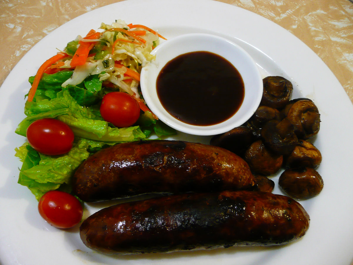 Spicy sausages, BBQ sauce, mushrooms and salad
