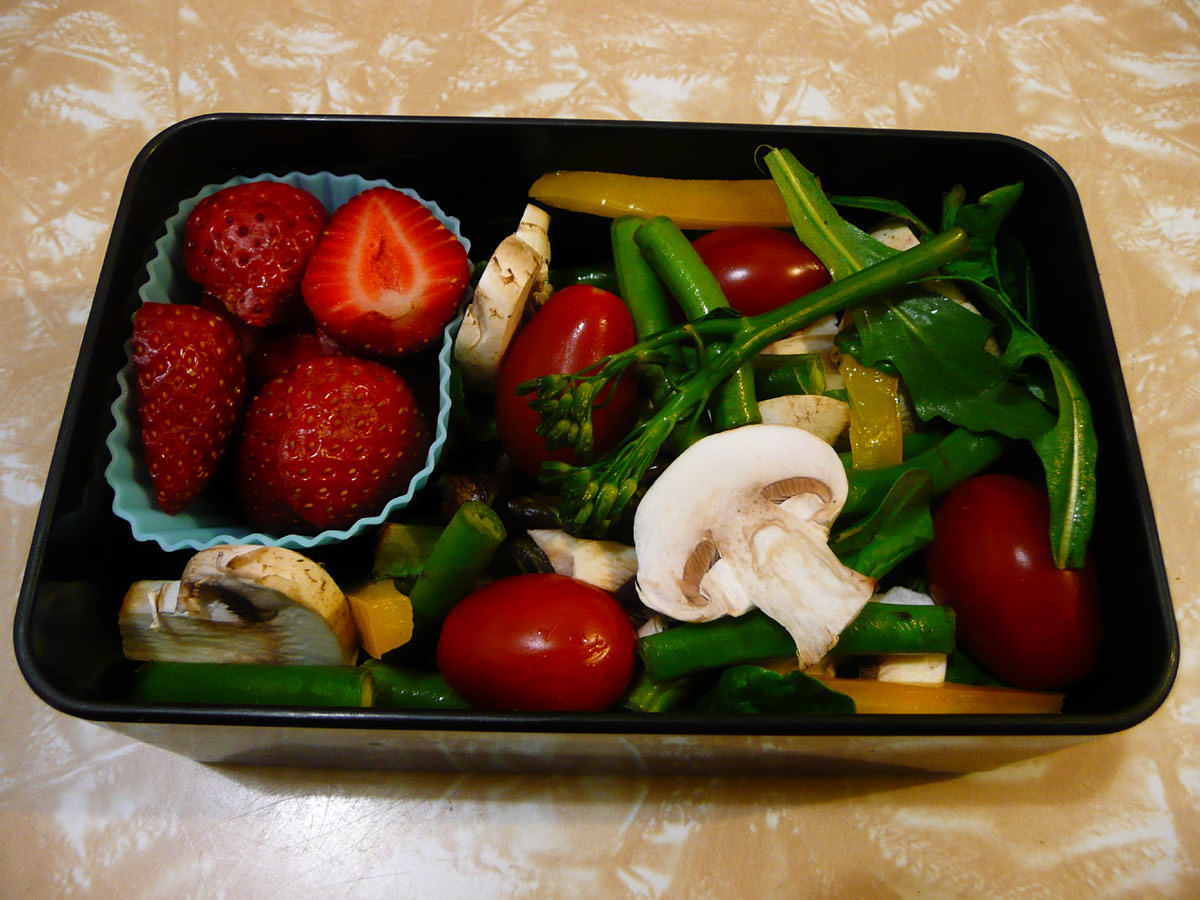 A big salad and strawberries
