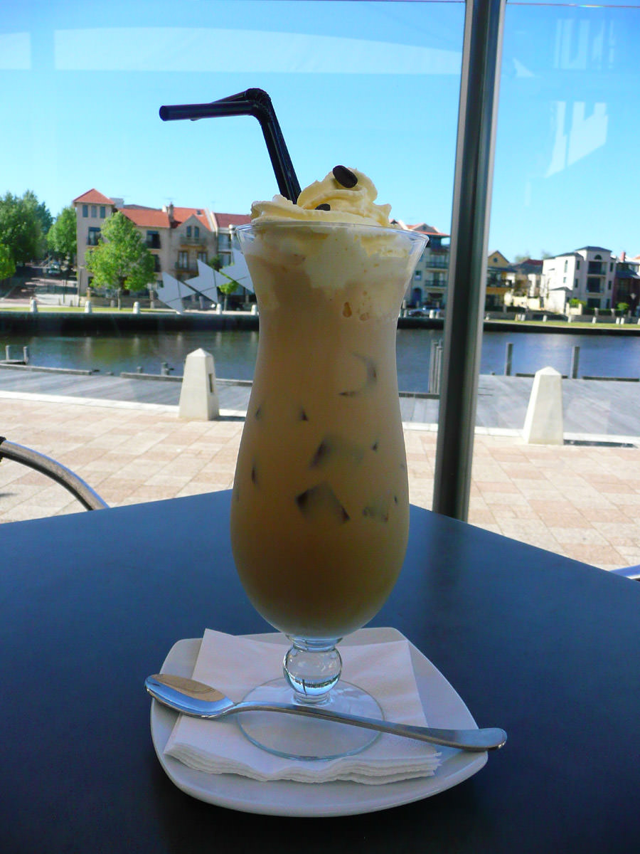 A tall iced coffee and a view of the water