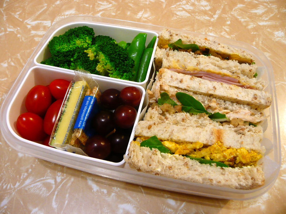 Bento - sandwiches, salad, fruit, cheese and mini sesame snaps