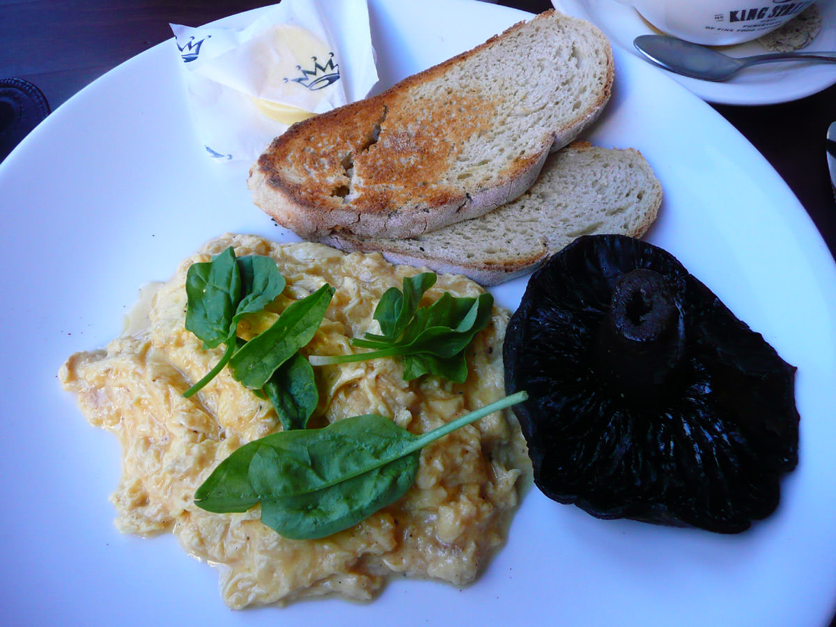 Scrambled eggs, grilled field mushroom and toast with butter