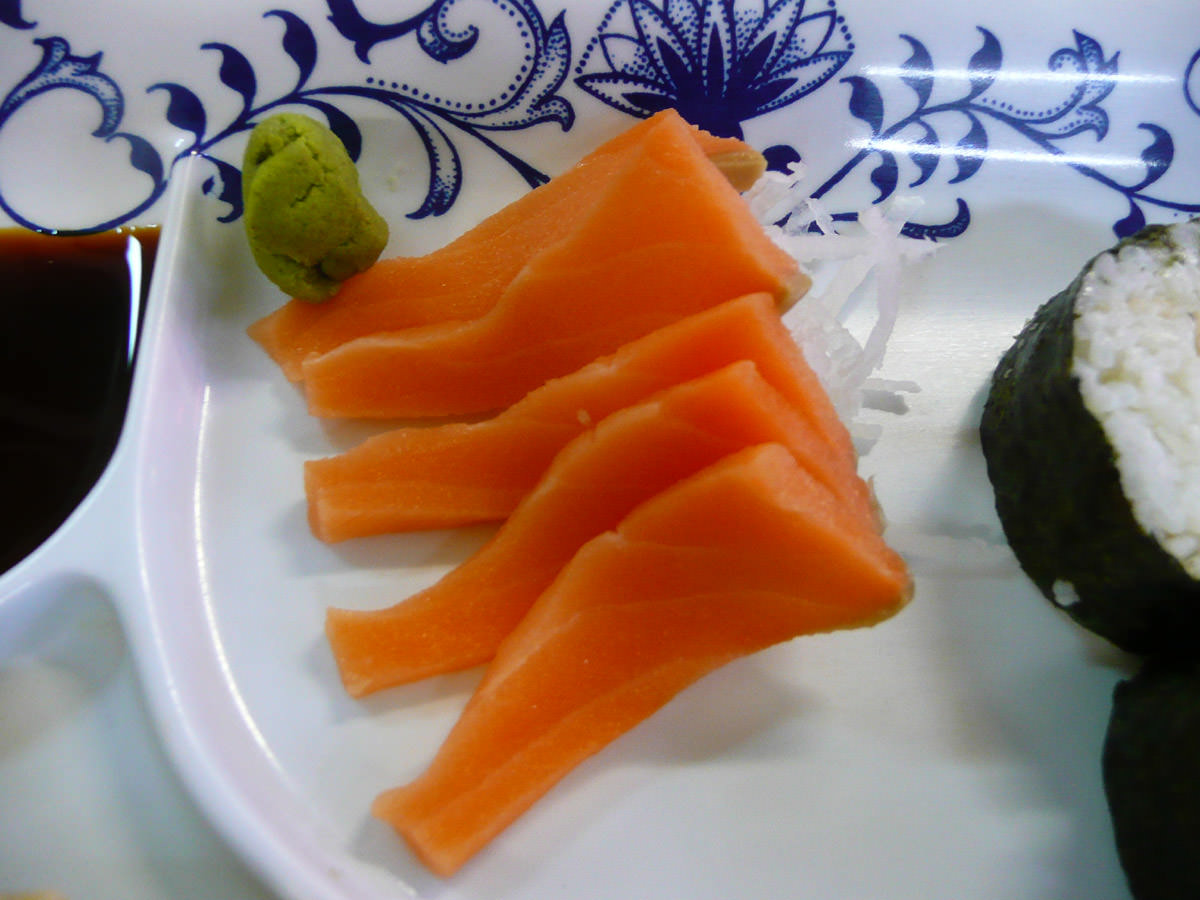 Salmon sashimi with a ball of wasabi