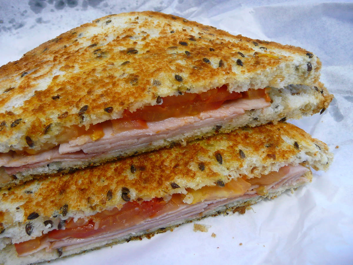 Toasted ham and tomato sandwich on multigrain close-up