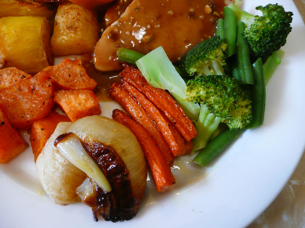 Roasted vegetables and steamed broccoli close-up