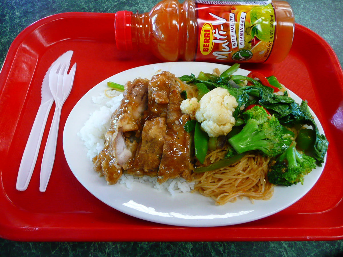 Lemon chicken, rice, noodles, stir-fried vegetables and Multi-V juice all on a tray