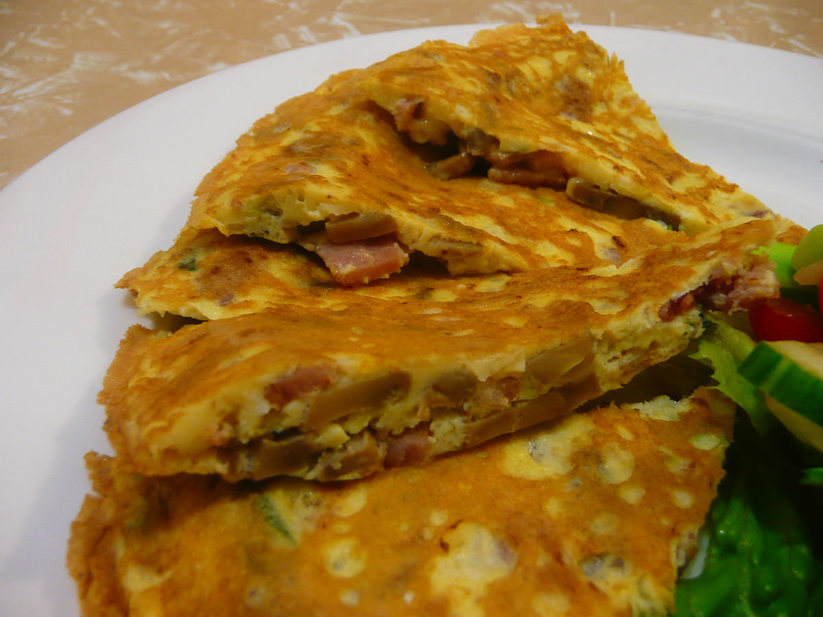 Omelette with bacon, mushrooms, garlic and onion - close-up