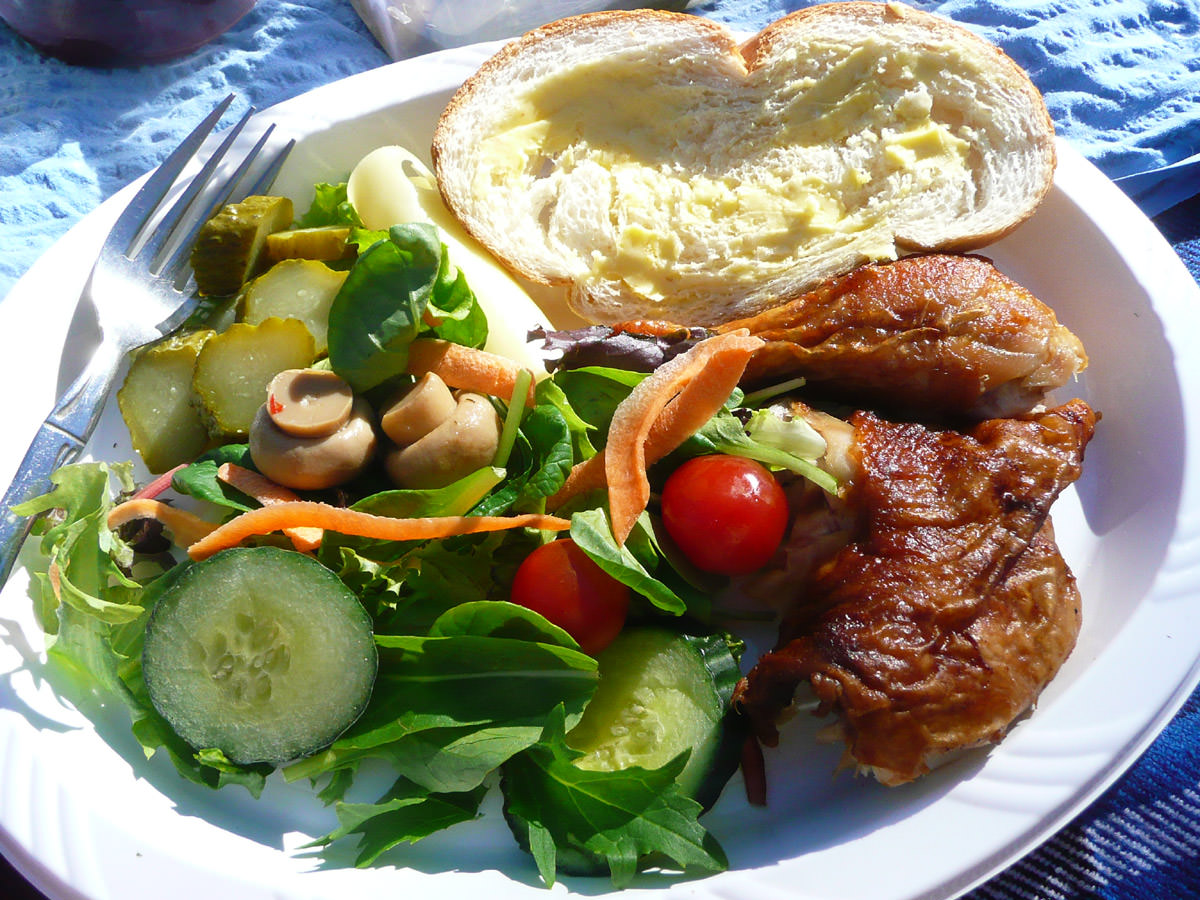 Chicken, salad, bread and pickles