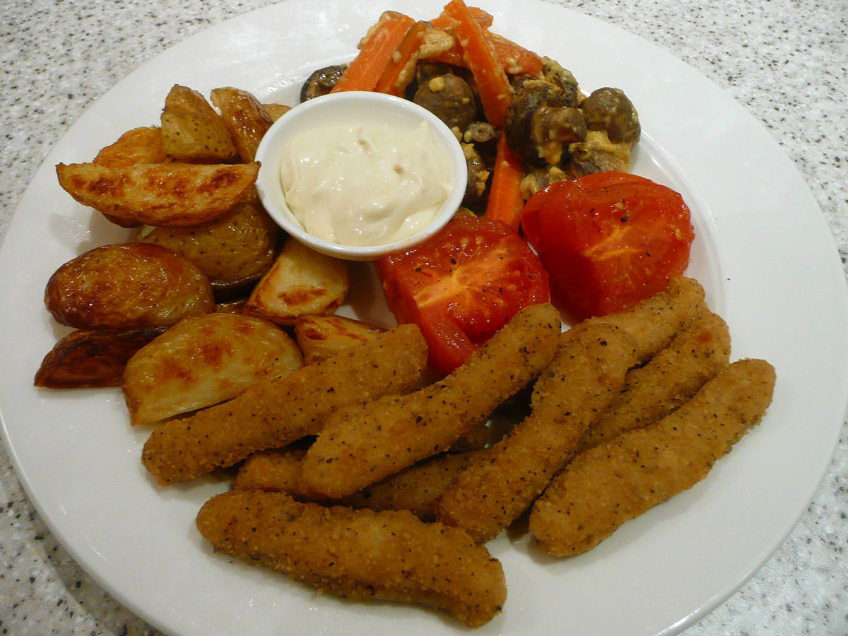 Chicken fingers, baked potato wedges, tomato and mushrooms and carrots