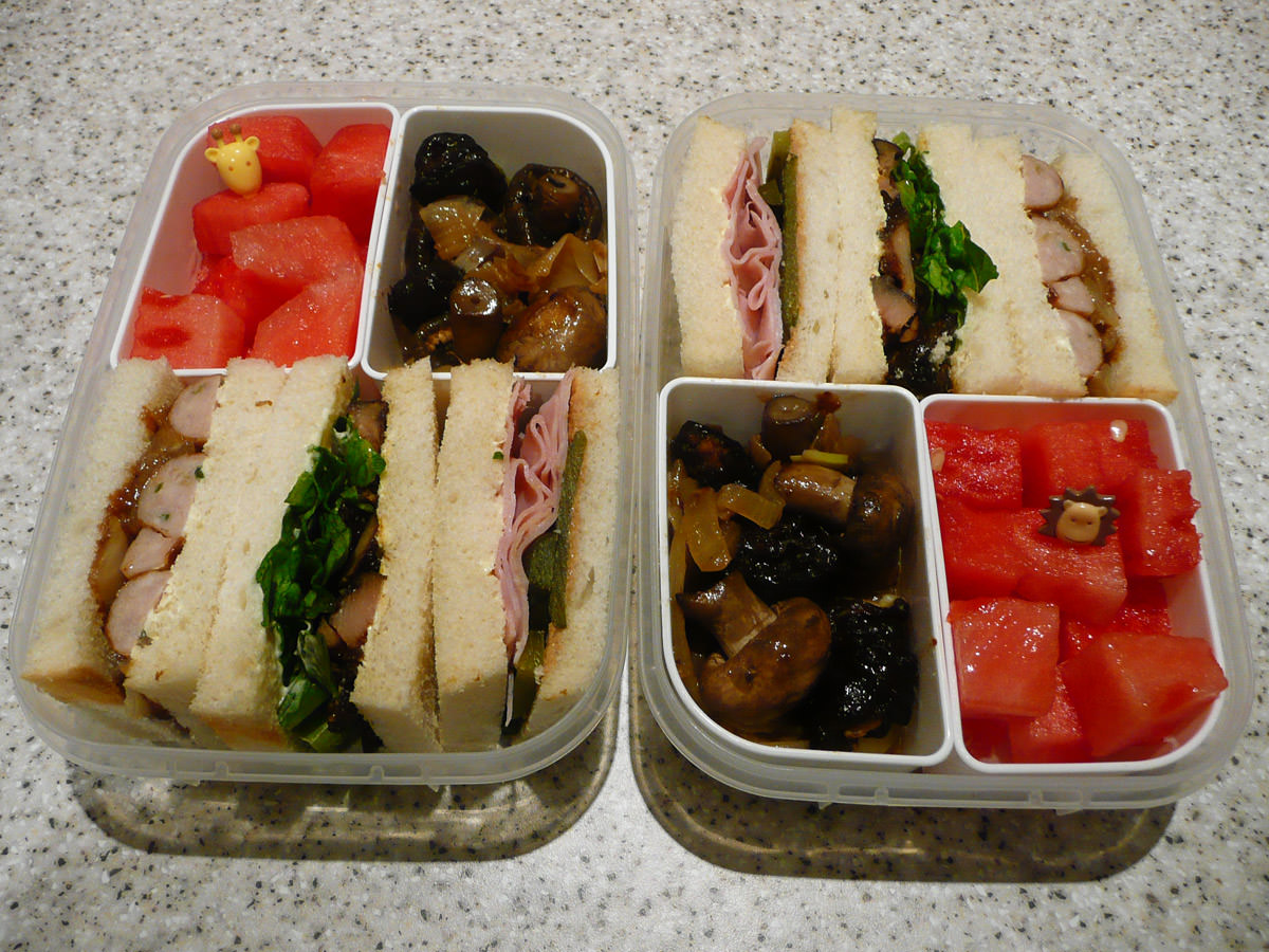 Bento lunches for two - sandwiches, onions and mushrooms, watermelon