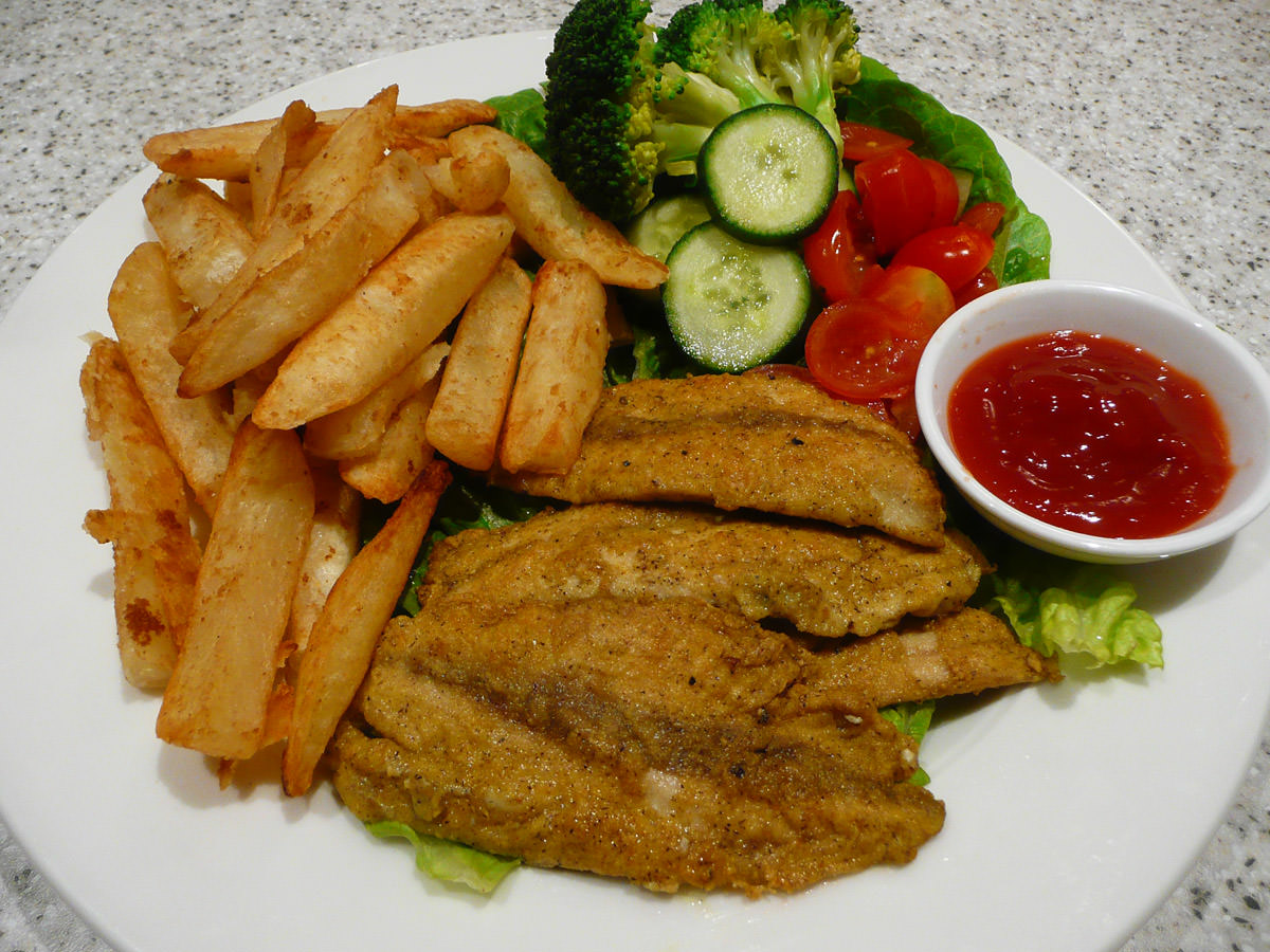 Curried fried herring fillets, salad and chips