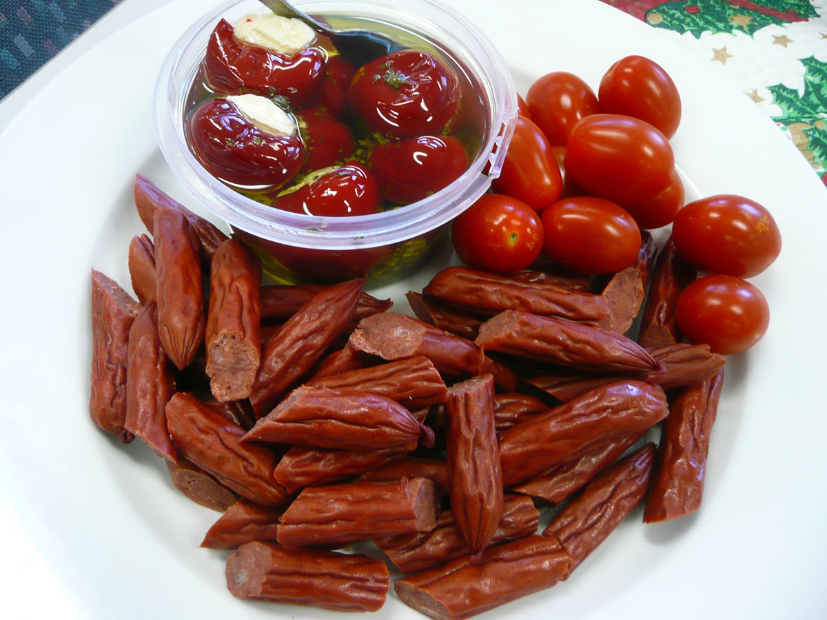 Salami sticks, cherry tomatoes and stuffed baby capsicum