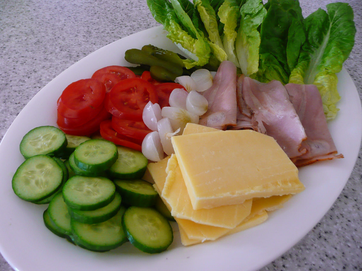 Cold roast pork, cheese, pickles and salad