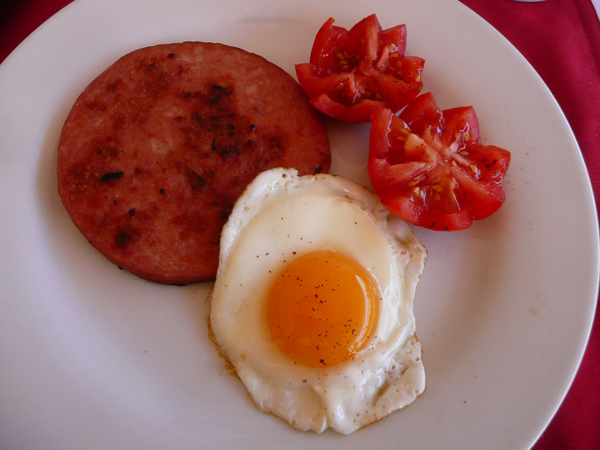 Ham steak, fried egg and tomato