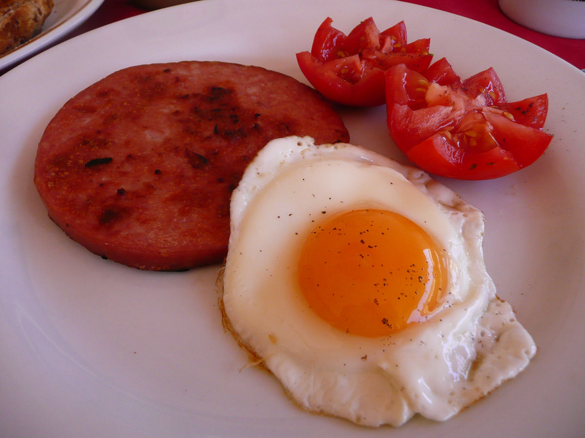 Ham steak, fried egg and tomatoes